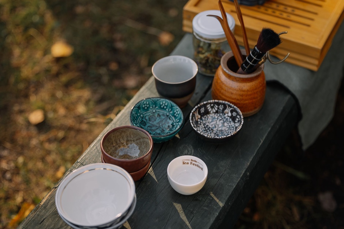 A traditional Chinese tea set with a ceramic teapot and small cups