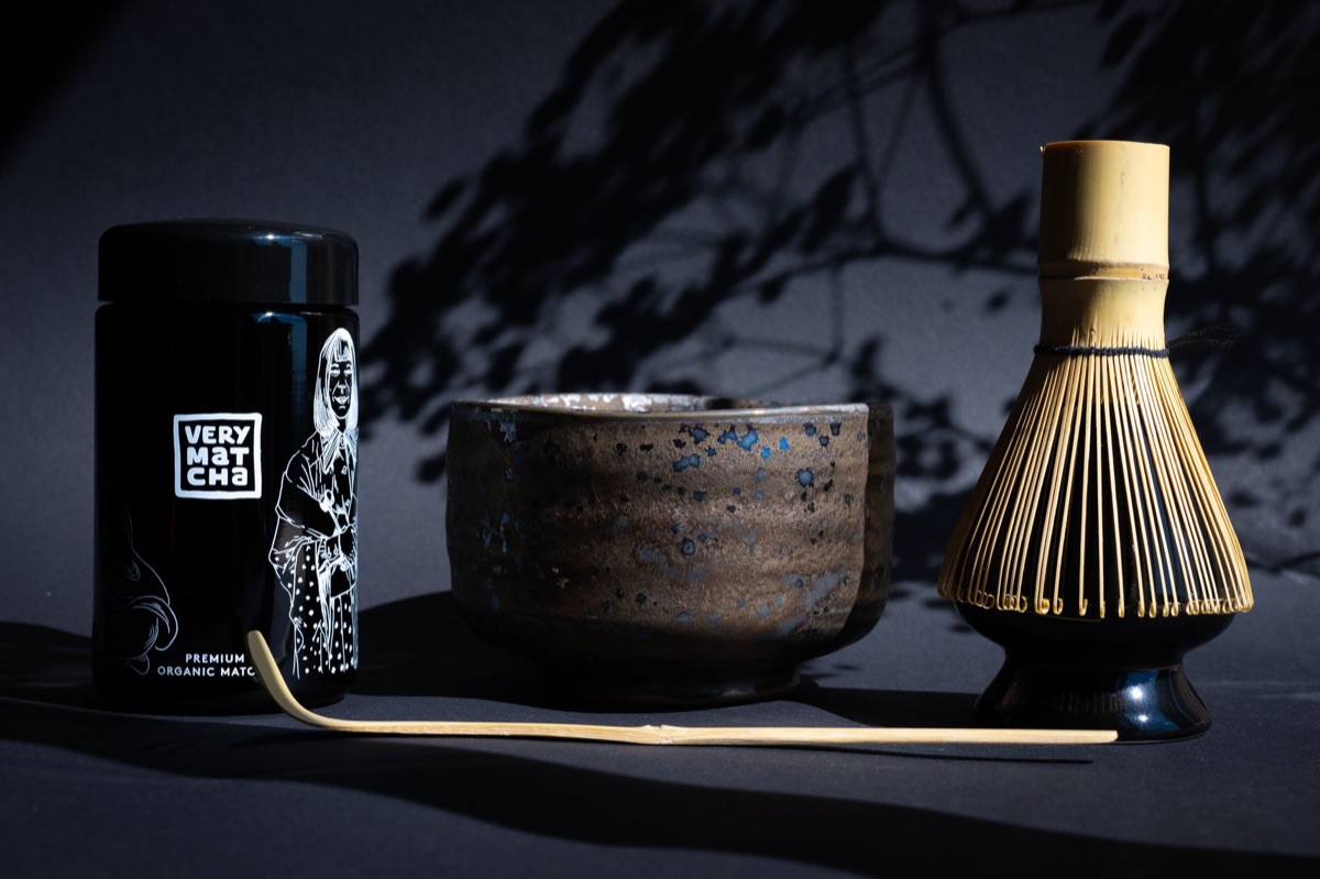 Traditional Japanese matcha tea set including a bamboo whisk and tea bowl